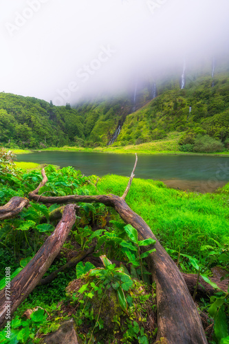 Azores scenic landscape, Flores island. Iconic lagoon with several waterfalls on a single rockface, flowing into lake Alagoinha. Best travel destination in Portugal, amazing vacations place. photo