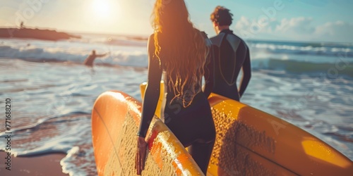 Couple with surfboards contemplating the waves. Shared love for surfing at sunset. © olga_demina