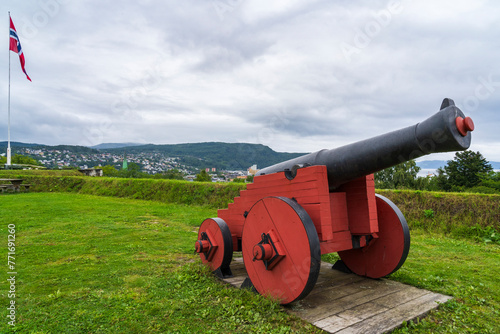 Old Cannon and Norwegian Flag at Kristiansten Festning Fortress in Trondheim photo