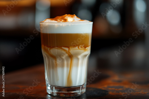 Café Latte in a Tall Glass - Perfectly prepared latte with a smooth foam layer, decorated with a caramel pattern