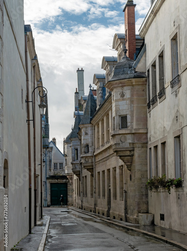 Urban vintage abstract background  featuring dark winter streets and architecture details of Dijon city in France.