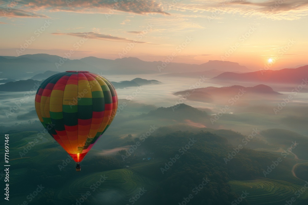 Colorful hot air balloon flying over misty mountains at sunrise, beautiful landscape background. Concept of travel and adventure with copy space. 