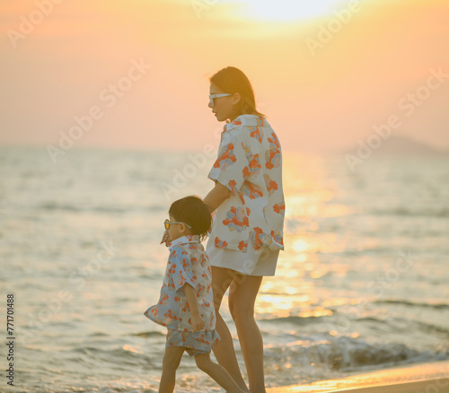 Asian boy and his mother Running around on the beach