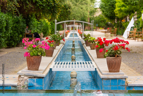 Water canals running through a Persian garden and mansion decorating the view of its residents.