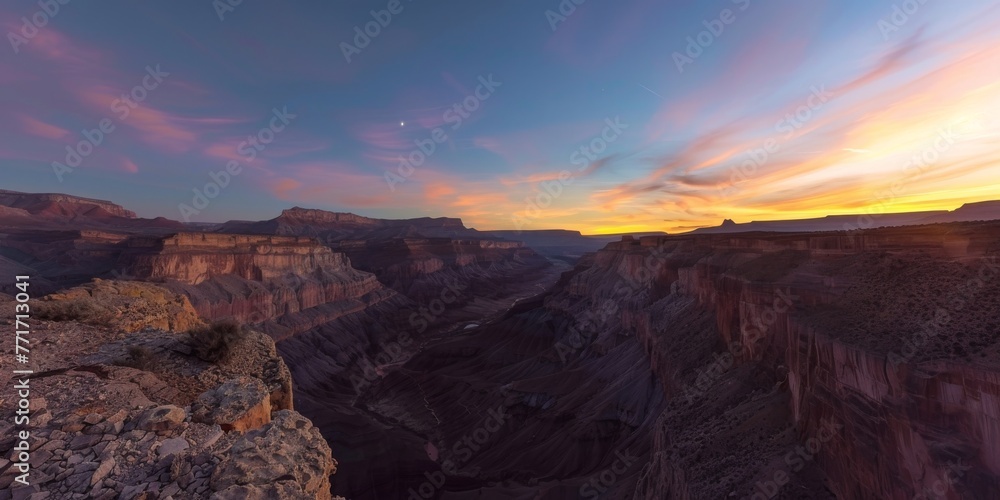 The sun sets over a majestic canyon nestled in the mountains, creating a stunning natural display of colors