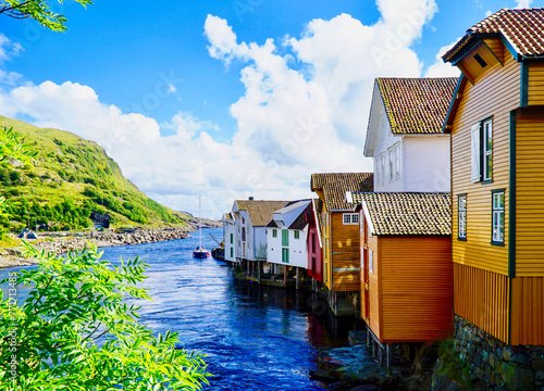 Photos Idyllic view of Sogndalsstrand waterfront with colorful wooden houses in summer