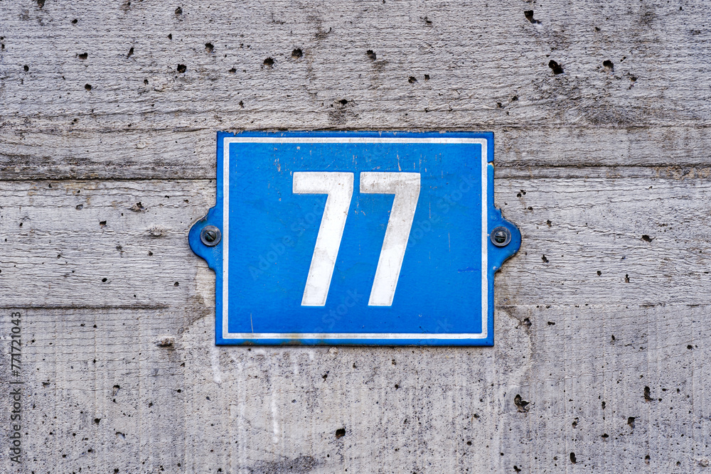 Close-up of concrete abstract house facade of building with house number 77 at Swiss City of Zürich. Photo taken March 21st, 2024, Zurich, Switzerland. Close-up of concrete abstract house facade of building with house number 77 at Swiss City of Zürich. Photo taken March 21st, 2024, Zurich, Switzerland.