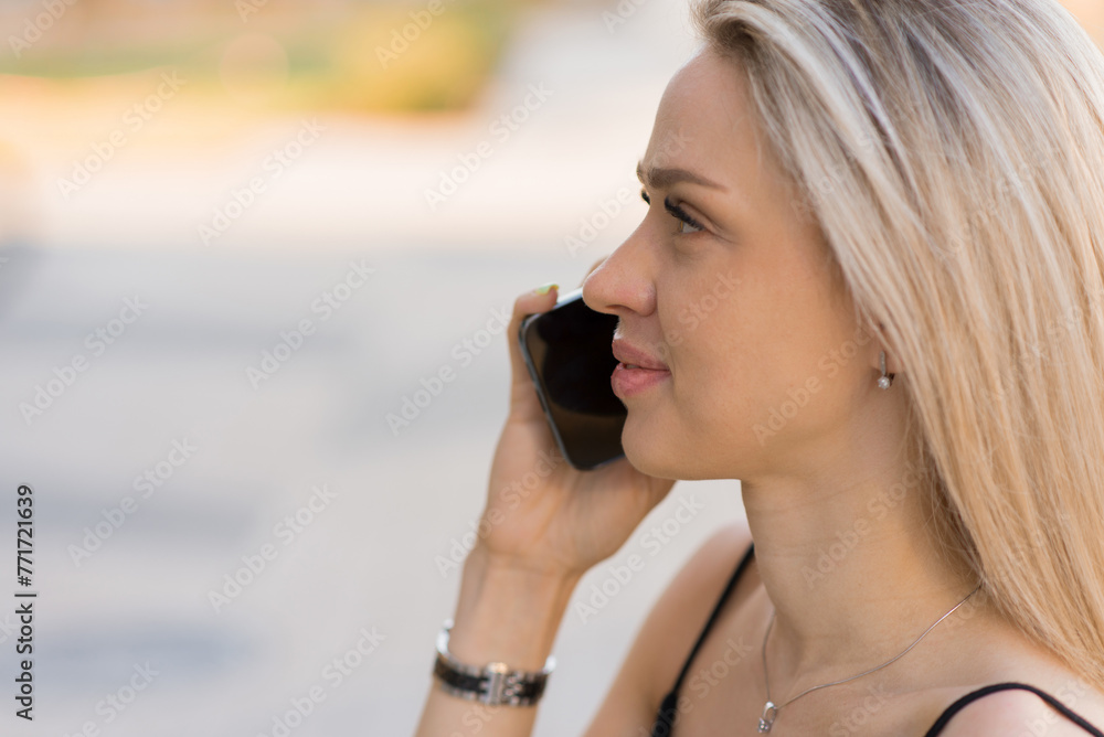 Happy white young woman talking with cellphone in city Happy white young woman talking with cellphone in city