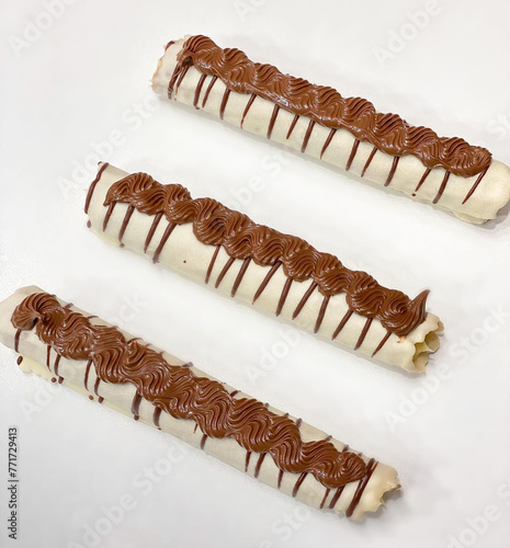 Delicious milk chocolate straw filled with Brazil nuts photo