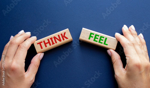 Think or Feel symbol. Concept word Think or Feel on wooden blocks. Businessman hand. Beautiful deep blue background. Business and Think or Feel concept. Copy space