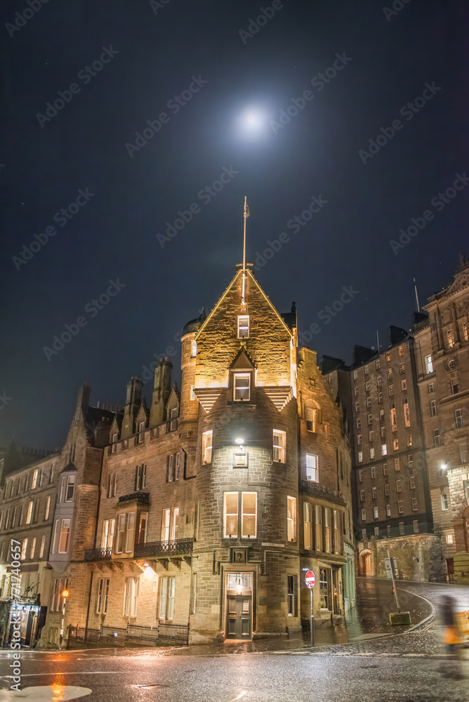 A night scene of old buildings on the corner of Market Street and Cockburn Street, under the moon. Edinburgh, Scotland