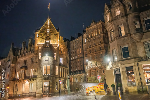 Old buildings lit up at night on the corner of Market Street and Cockburn Street in Edinburgh city centre, Scotland