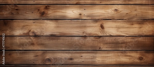 A detailed shot of a brown hardwood plank wall with a blurred background, showcasing the intricate pattern of the wood grain and texture