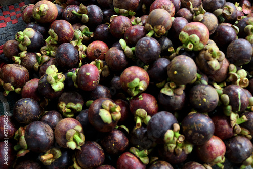 Photo of piles of mangosteen fruit at the fruit market