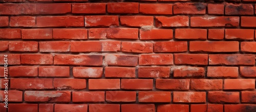 An intricate pattern of red brickwork on a wall, showcasing symmetry and precision in placement. The mortar between each rectangle brick adds depth and texture