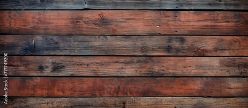 A closeup of a brown hardwood wall with a row of rectangular wooden planks, showcasing a beautiful wood stain pattern. The building material resembles brickwork