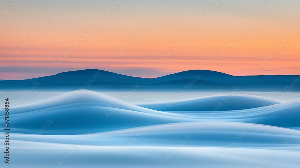  Mountain range silhouette bathed in sunset light, snow-capped peak viewed from distant hills