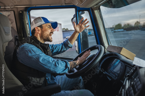 An angry truck driver is driving a truck and is annoyed with people who disturb the traffic photo