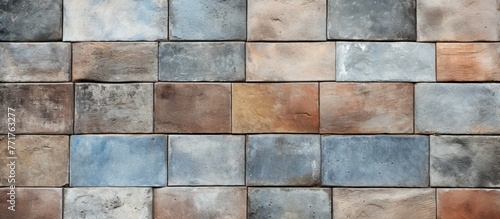 A detailed closeup of a rectangular brick wall showcasing a variety of colors and textures, creating a unique pattern resembling an artistic composition