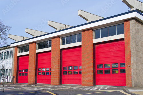 Fire brigade station building with red roller shutter doors