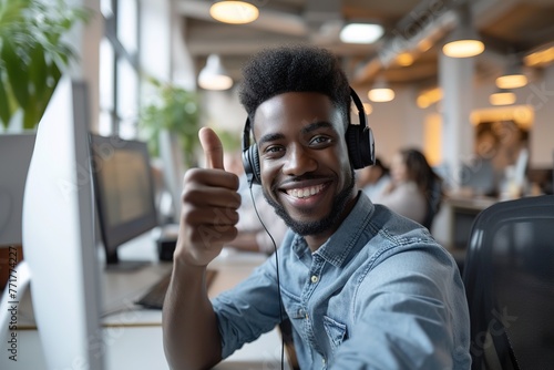 Happy afro male customer service call center with thumb up.