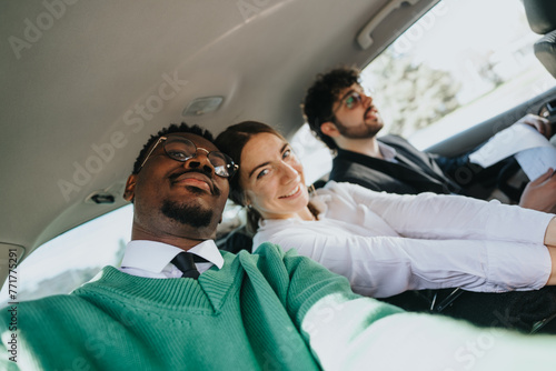 Three business professionals carpooling, enjoying a casual conversation while traveling in a vehicle. A sense of community and shared responsibility.