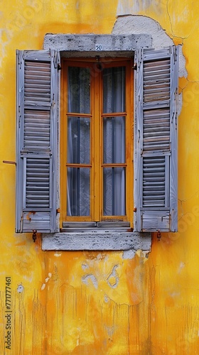 Yellow Building With Two Windows and Shutters