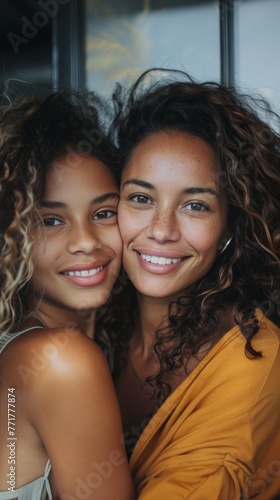 Two Young Women Hugging by Window