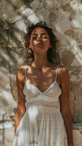 Woman in White Dress by Stone Wall