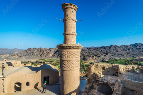 So called shaking minaret in historic abandoned mud part of Kharanaq village, Iran photo