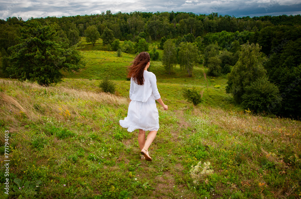 Woman in windy valley. Woman walk in mountain valley. Landscape of summer nature. Travel girl walking on mountain valley outdoor. Freedom and wanderlust. Carpathians mountain. Carefree Woman in windy valley. Woman walk in mountain valley. Landscape of summer nature. Travel girl walking on mountain valley outdoor. Freedom and wanderlust. Carpathians mountain. Carefree