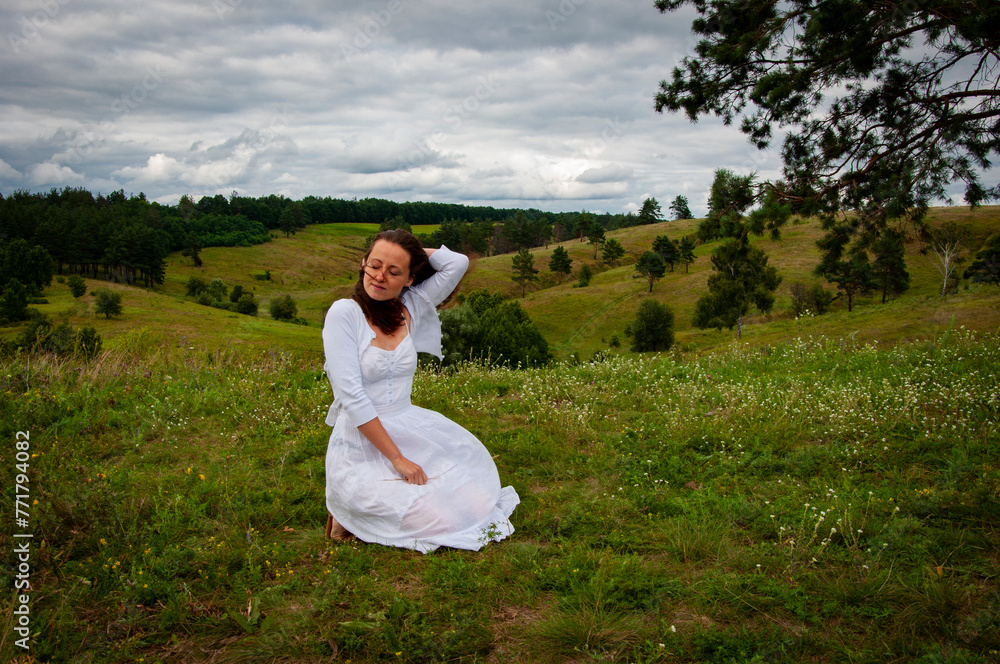 Landscape of summer nature. Beautiful girl at nature valley outdoor. Freedom lifestyle. Carpathians mountain girl. Woman in windy valley. Woman in the mountain valley. Copy space Landscape of summer nature. Beautiful girl at nature valley outdoor. Freedom lifestyle. Carpathians mountain girl. Woman in windy valley. Woman in the mountain valley. Copy space