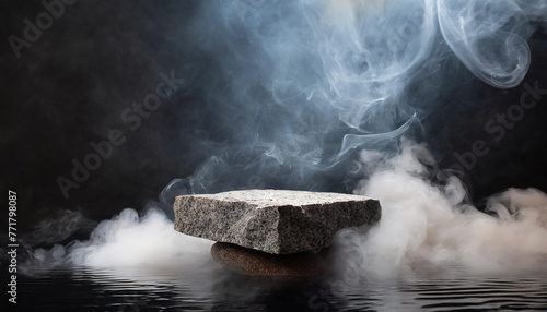 Gray natural raw granite stone surrounded by water and smoke. Abstract podium, product presentation