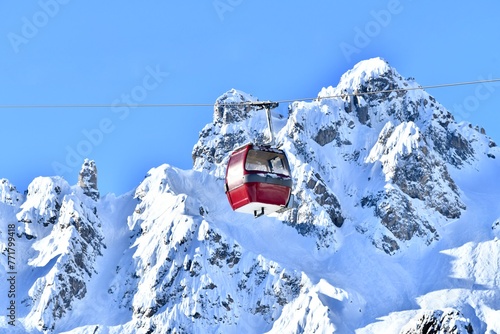 Vintage ski gondolas over slopes of French Alps by winter