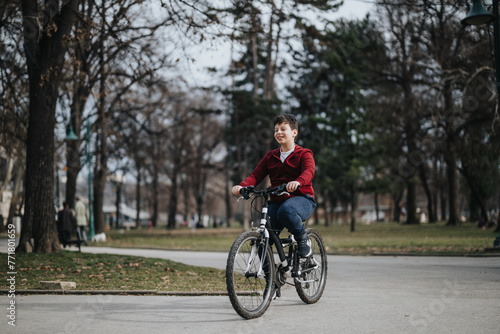 A happy boy rides his bicycle through a leafy urban park, enjoying the freedom and joy of a relaxing weekend outdoors.