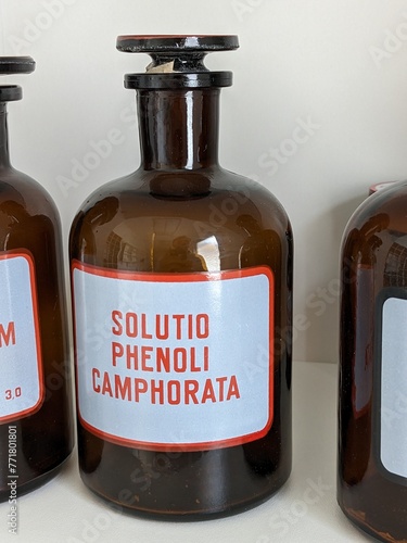 Old fashioned medicine glass bottles,brown vintage pharmacy bottles for medicinal substances-Solutio phenoli camphorata photo