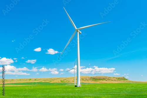 Wind turbine in a summer farm field in southern alberta Canada