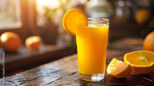 Freshly squeezed orange juice in a glass with orange slices on the side. A refreshing glass of freshly squeezed orange juice with a vibrant slice of orange on a rustic wooden table. 