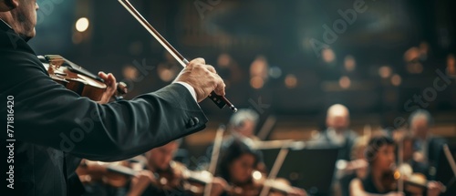 Performing symphony orchestra background, close-up of hands of conductor. photo