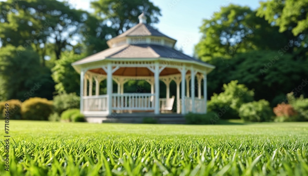In the city park, in the middle of a green lawn, there is a beautiful gazebo for relaxation. Well-groomed paths along the green lawn. Texture of grass, lawn.