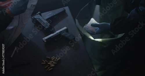 Crime Scene Investigators In Drug Den, Guns, Bullets, and Drugs. Officer Pulls baggy of white drug from bag, Flash light in low light, Slow Motion