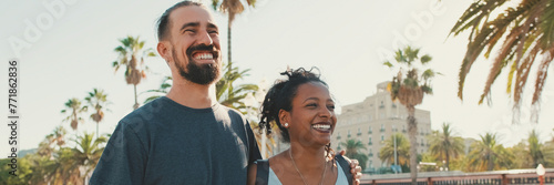 Happy interracial couple walking down the street talking and smiling. Man hugs the woman, Panorama