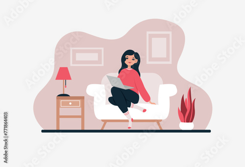 Girl sitting on the sofa with a laptop.