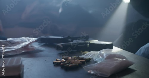 Crime Scene Investigators In Drug Den, Guns, Bullets, and Drugs. Officers examine white drug in baggy, Examine gun and Uzi, Flash light in low light, Slow Motion