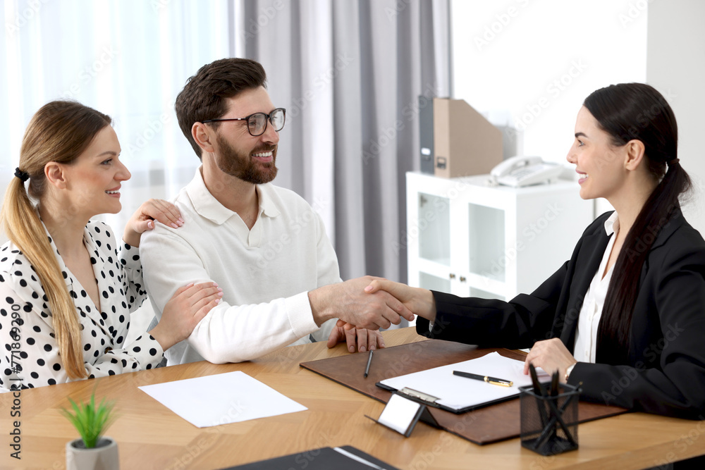 Lawyer shaking hands with clients in office Lawyer shaking hands with clients in office