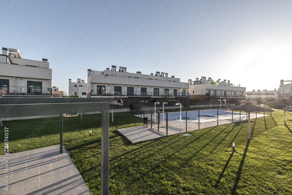 Community pool within the garden of a residential development of single-family homes Community pool within the garden of a residential development of single-family homes