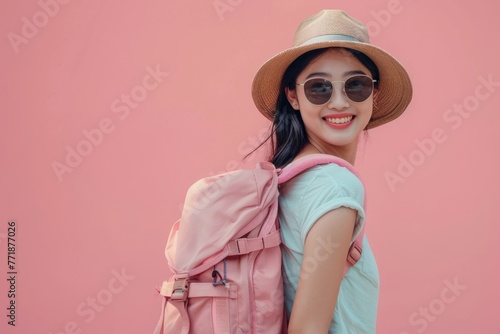 Happy young Asian female tourists wear beach hats, sunglasses and backpacks on holiday trips.