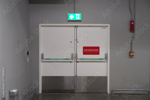 Fire extinguishers and fire escape door in building