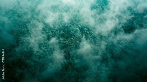 An aerial drone over the cloudy surface of a tropical rainforest, in a texture rich, emerald, and dark green style.