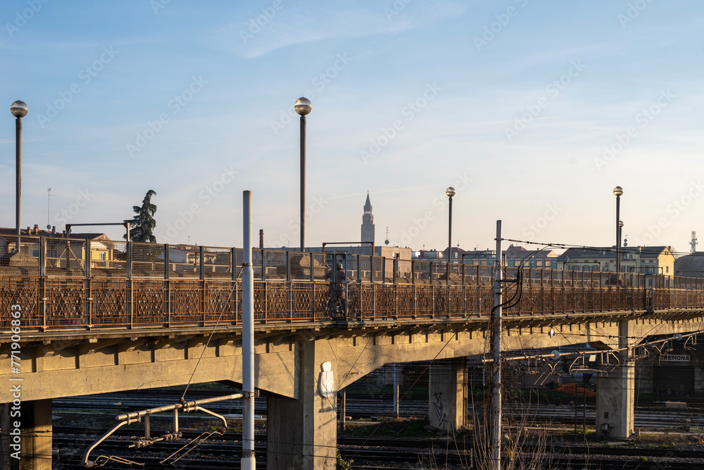 Bridge over the Cremona railway with the bell tower, the Torrazzo, in the background.